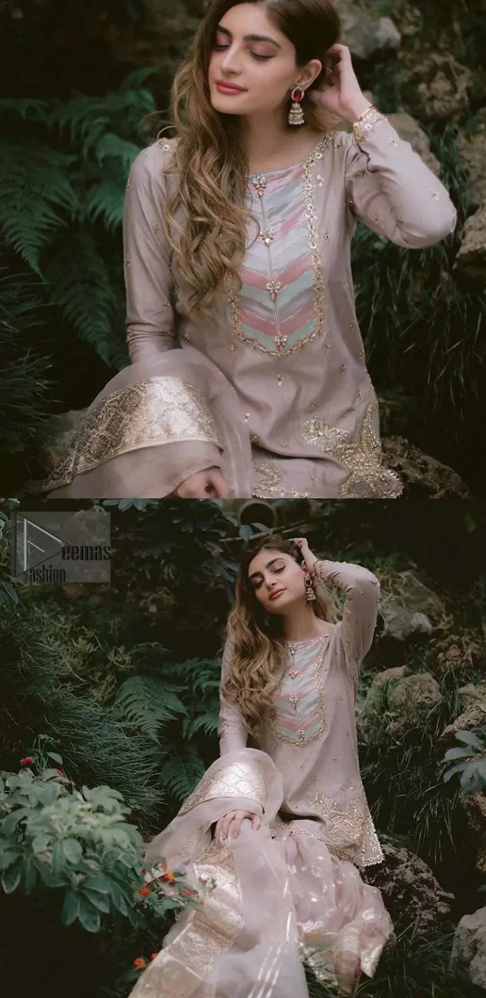 This dress is majestic beauty and perfect for your nikah or engagement day. Delicately crafted and personifying chic elegance with an element of grandiose. The beautiful neckline decorated with multiple color appliques, swarovski crystals and zardosi work. The daman is emphasized with golden kora, dabka,tilla and gota work to convey a classic look. Having full length sleeves adorned with tiny motifs scattered all over. This outfit is coordinated with self printed organza gharara. Pair it up with matching organza dupatta.