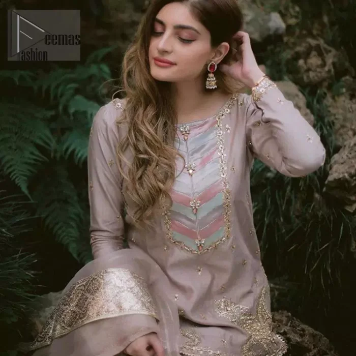 This dress is majestic beauty and perfect for your nikah or engagement day. Delicately crafted and personifying chic elegance with an element of grandiose. The beautiful neckline decorated with multiple color appliques, swarovski crystals and zardosi work. The daman is emphasized with golden kora, dabka,tilla and gota work to convey a classic look. Having full length sleeves adorned with tiny motifs scattered all over. This outfit is coordinated with self printed organza gharara. Pair it up with matching organza dupatta.
