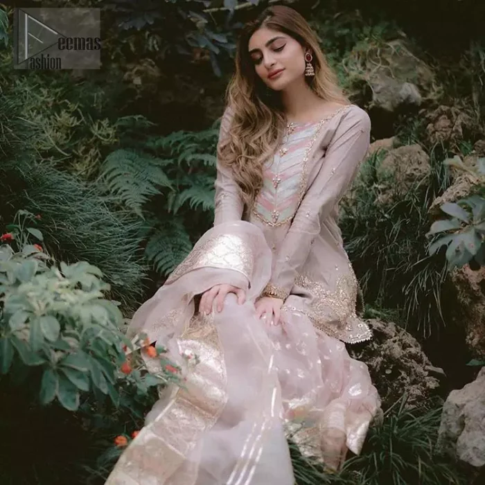 This dress is majestic beauty and perfect for your nikah or engagement day. Delicately crafted and personifying chic elegance with an element of grandiose. The beautiful neckline decorated with multiple color appliques, swarovski crystals and zardosi work. The daman is emphasized with golden kora, dabka,tilla and gota work to convey a classic look. Having full length sleeves adorned with tiny motifs scattered all over. This outfit is coordinated with self printed organza gharara. Pair it up with matching organza dupatta.