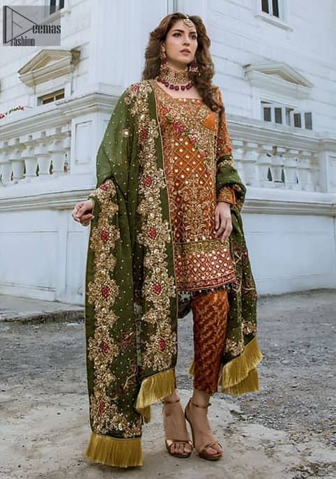 Bring out your beauty with this traditional yet modern outfit for mehndi mayon day. Make your wardrobe more interesting with this shabby chic statement intensified with rich thread embroidery and zardosi work all over the front and geometric patterns at daman that instantly draws attention. It is highlighted with antique shaded kora, dabka, sequins and pearls. Having full length sleeves adorned with floral booties. It comprises with cigarette pants. It is coordinated with beautiful dupatta with thick embellished border on two sides and scattered sequin on the ground to convey a classic look.