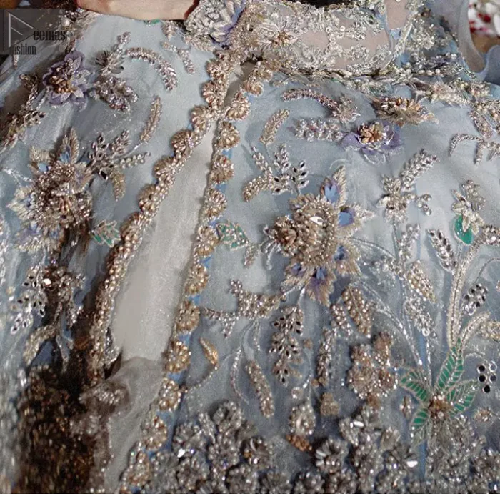 Reflecting royalty and the majestic beauty of statuesque shape and silhouette this dress is perfect for your walima and engagement function. Add some super cool twist to your look with this subtle colors in intricately embroidered frock. Capture the attention with fascinating embellishment on neckline with silver and dull golden kora, dabka, pearl and sequins. Having full length sleeves adorned with floral motifs. It comprises with ivory sharara. Thin border with floral motifs on all four sides of the dupatta which have gold tila embroidery with kora and dabka. 