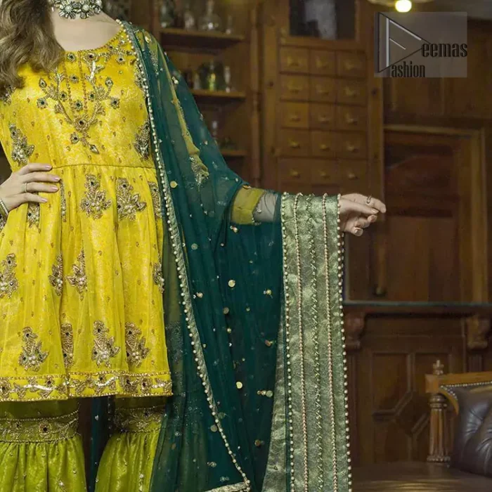 This dress is perfect for mehndi day. Delicately crafted and personifying chic elegance with an element of grandiose. This mehendi and mayun dress is beautifully sculptured with floral embroidery on neckline adorned with scattered embellished with dull golden kora, dabka, pearl and sequins work all over. Having full length sleeves adorned with motifs. It comprises with mehndi green gharara sprinkled with sequins to convey a classic style. Beautifully coordinated with bottle green dupatta with thick lace border.