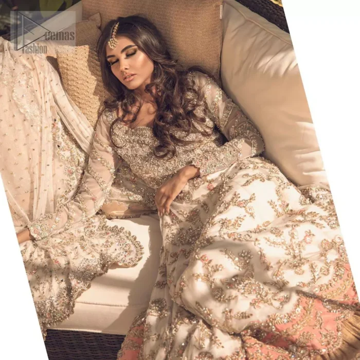 Reflecting exuberant color play in this ethereal piece meticulously highlighted with antique shaded kora, dabka, tilla and sequins. The frock is delicately crafted with floral bunches, fully embellished bodice and scalloped applique daman to give it a perfect ending. The contemporary yet traditional embroidered stripes on the sleeves completes the look. The outfit is comprises with mustard crushed sharara. It is paired with ivory chiffon dupatta with sequins chann all over and two sided embroiderd pallu.
