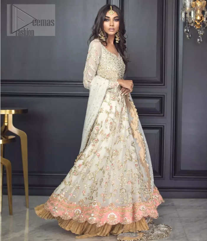 Reflecting exuberant color play in this ethereal piece meticulously highlighted with antique shaded kora, dabka, tilla and sequins. The frock is delicately crafted with floral bunches, fully embellished bodice and scalloped applique daman to give it a perfect ending. The contemporary yet traditional embroidered stripes on the sleeves completes the look. The outfit is comprises with mustard crushed sharara. It is paired with ivory chiffon dupatta with sequins chann all over and two sided embroiderd pallu.