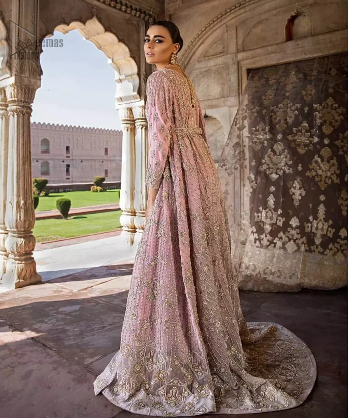 Exude elegance and class in this back trail maxi finessed with beautiful embellishment. The outfit is beautifully sculptured with floral embroidery, adorned with vertical lines and fixed waist belt embellished with silver and light golden kora, dabka, tilla and sequins work all over. The back of the outfit has an artistically designed motif. The outfit is styled with a hand embellished crystal belt. It comprises with cigarette pants and light pink net dupatta ornamented with sprinkled sequins on the ground and four sided light border.