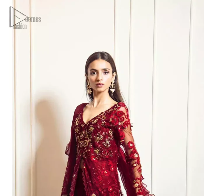 This exceptionally detailed front open gown lehenga is cut in a seductive fit and flare silhouette that’s sure to turn heads on your big day. The bodice with plunging V-neckline is adorned in richly floral lace with fabulous sparkle. Furthermore the bodice is highlighted with golden zardozi work and floral applique. Center slits and bottom of the gown is beautifully decorated with floral lace. It is coordinated with maroon crushed lehenga and organza dupatta. 