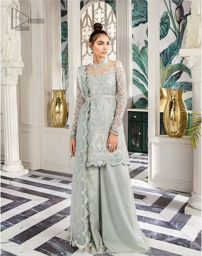 Delicately crafted and personifying chic elegance with an element of grandiose. This outfit is aesthetically designed with motifs and floral patterns, embellished with kora, dabka, nakshi, sequins, cutdana and  crystals. The detailed scalp border gives a perfect ending to this peplum. Beautifully designed sleeves is an amalgamation of floral design elements. Sharara comprises of sequins spray all over. The dupatta incorporates beautifully designed scalloped borders on all four sides and tiny floral motifs.