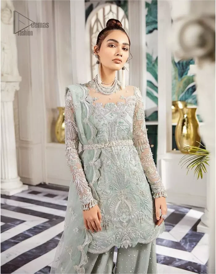 Delicately crafted and personifying chic elegance with an element of grandiose. This outfit is aesthetically designed with motifs and floral patterns, embellished with kora, dabka, nakshi, sequins, cutdana and  crystals. The detailed scalp border gives a perfect ending to this peplum. Beautifully designed sleeves is an amalgamation of floral design elements. Sharara comprises of sequins spray all over. The dupatta incorporates beautifully designed scalloped borders on all four sides and tiny floral motifs.