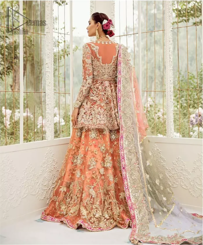 Captured in traditional silhouette, The bridal stands out due to its uniqueness and the perfect fusion of modern cut and traditional embroidery. This front open short frock is highlighted with kora, dabka, tilla, sequins and pearls. It comes with full embellished lehenga adorned with floral bunches, applique on the hemline and sequins spray all over it. It is coordinated with organza dupatta which is sprinkled with tiny floral motifs all over and a thick embellished border on all four sides with applique details.