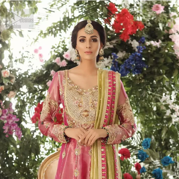Nothing speaks of femininity and class louder than this mehndi outfits for bridesmaids. This beautiful mehndi dress comes with anarkali frock with beautiful embellished motifs around the scalloped hemline and vertically worked gold lines and heavily embellished neckline with light golden, champagne and antique shaded zardozi work. It comes with sharara adorned with colored floral embroidery with champagne embellishment. Complete the look with parrot green dupatta having four sided applique borders and sequins spray on the ground.
