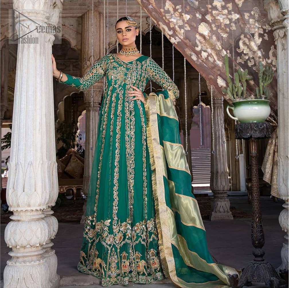 Steal the moment with our emerald green floor length angrakha emphasized with traditional neckline and intricate floral daman enhanced with light golden kora, dabka and sequins. The detailed zardosi work on sleeves and vertical panel stripes ornamented with gold kora and dabka embroidery on the bodice, the thick borders and floral bunches refined the classical royal look. Style it up with organza dupatta adorned with four sided kiran.
