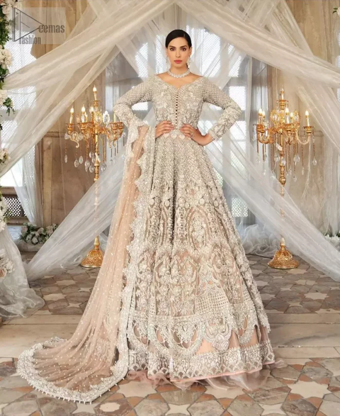 Paint a picture of pure elegance with this beautiful pishwas. This dress is beautifully sculptured with floral embroidery, adorned with geometric patterns embellished with silver kora, dabka, pearls and sequins work all over. The detailed scallop border gives a perfect ending to this pishwas. The lehenga is emphasized with embellished bottom that gives perfect ending to thisoutfit. It is coordinated with net dupatta sprinkled with chann all over and finished with embroidered border on four sides which makes this outfit more beautiful.