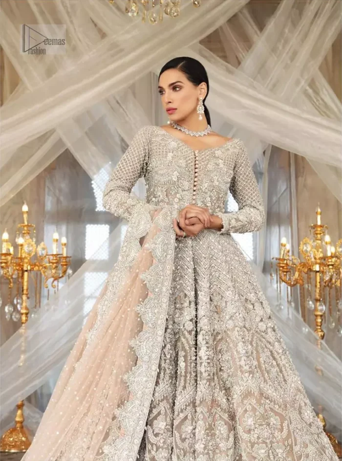 Paint a picture of pure elegance with this beautiful pishwas. This dress is beautifully sculptured with floral embroidery, adorned with geometric patterns embellished with silver kora, dabka, pearls and sequins work all over. The detailed scallop border gives a perfect ending to this pishwas. The lehenga is emphasized with embellished bottom that gives perfect ending to thisoutfit. It is coordinated with net dupatta sprinkled with chann all over and finished with embroidered border on four sides which makes this outfit more beautiful.