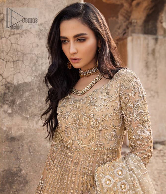Captured in traditional silhouette, The bridal stands out due to its uniqueness and the perfect fusion of modern cut and traditional embroidery. It is highlighted with kora, dabka, tilla, sequins and pearls. Pishwas is enhanced with zardosi work on bodice, vertical lines and the daaman is emphasized with intricate zardosi details that gives perfect ending to this outfit. A handcrafted pale gold lehenga finished with thick embellished borders completes the look. The outfit is coordinated with chiffon dupatta with hand embroidered borders on all four sides and geometric patterns on the ground.