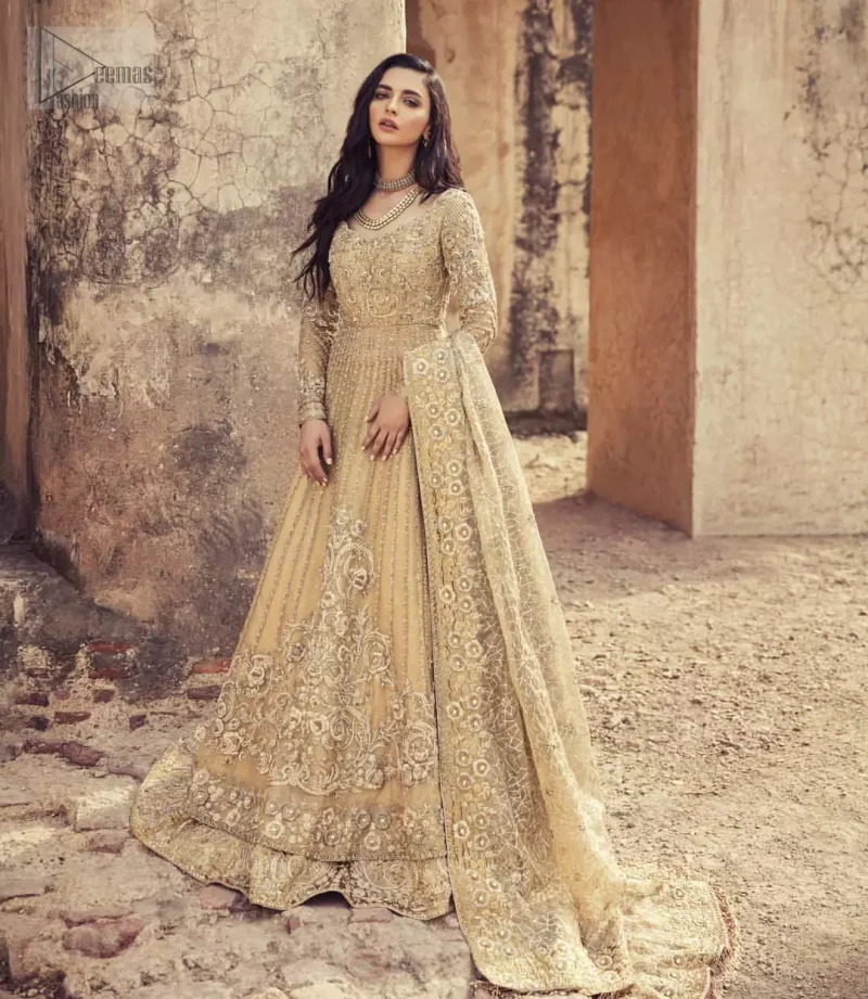 Captured in traditional silhouette, The bridal stands out due to its uniqueness and the perfect fusion of modern cut and traditional embroidery. It is highlighted with kora, dabka, tilla, sequins and pearls. Pishwas is enhanced with zardosi work on bodice, vertical lines and the daaman is emphasized with intricate zardosi details that gives perfect ending to this outfit. A handcrafted pale gold lehenga finished with thick embellished borders completes the look. The outfit is coordinated with chiffon dupatta with hand embroidered borders on all four sides and geometric patterns on the ground.