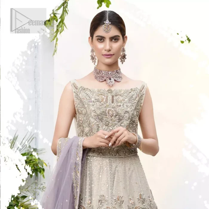 The ultimate in feminine elegance with fine detail to die for. Our bride makes a statement in this stunningly floraison, perfect blend of glamour and tradition with outstanding craftsmanship and gorgeous detailing. This front open pishwas is gorgeously decorated with floral bunches all over done with antique shaded zardozi work. It comprises with light beige jamawar lehenga with zardozi detail on the bottom. Style it up with light purple net dupatta sprinkled with sequins and four sided embellished border.