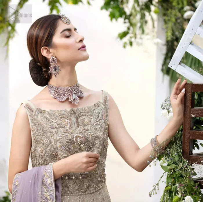 The ultimate in feminine elegance with fine detail to die for. Our bride makes a statement in this stunningly floraison, perfect blend of glamour and tradition with outstanding craftsmanship and gorgeous detailing. This front open pishwas is gorgeously decorated with floral bunches all over done with antique shaded zardozi work. It comprises with light beige jamawar lehenga with zardozi detail on the bottom. Style it up with light purple net dupatta sprinkled with sequins and four sided embellished border.