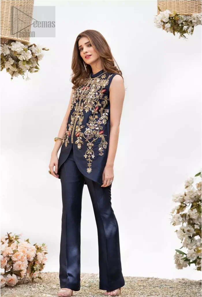 This outfit is timeless beauty. Boost your confidence and style in this glamorous attire accentuated with finest zardozi and thread work. The shirt is delicately handcrafted with golden zarozi work and multiple color thread embroidery. Style it up with navy blue bell bottom pants which complete the look.
