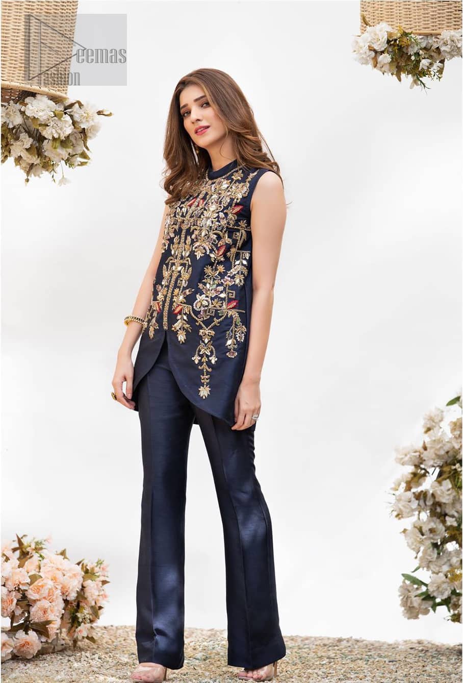 This outfit is timeless beauty. Boost your confidence and style in this glamorous attire accentuated with finest zardozi and thread work. The shirt is delicately handcrafted with golden zarozi work and multiple color thread embroidery. Style it up with navy blue bell bottom pants which complete the look.
