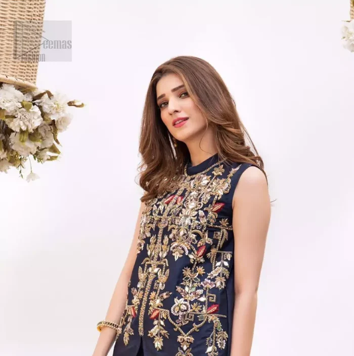 This outfit is timeless beauty. Boost your confidence and style in this glamorous attire accentuated with finest zardozi and thread work. The shirt is delicately handcrafted with golden zarozi work and multiple color thread embroidery. Style it up with navy blue bell bottom pants which complete the look.