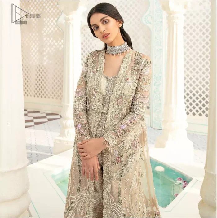An example of beauty and elegance. A perfect ensemble for this festive season with divine detailing of thread embroidery, color balance and well-crafted scalloped bottom. The front open gown is sculptured with light golden zardozi work all over and multiple color thread embroidered floral. Complete the look with inner jumpsuit style it up with a fixed waist belt. Paired it up with organza dupatta adorned with scattered floral motifs.