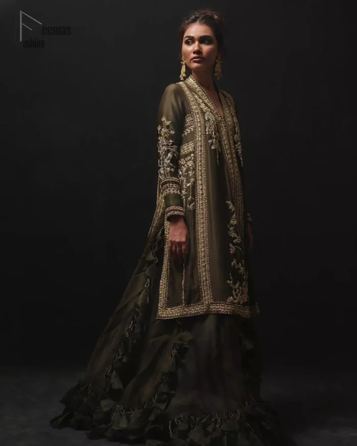 Discover your inner charm with this ravishing front open shirt adorned with golden embellishment. A delicate arrangement of hand embellished floral bunches with zardozi work. Full sleeves and side slits are also decorated with kora, dabka, tilla and sequins work all over. It is coordinated with frilled sharara gives it a perfect look. Style it up with olive green dupatta sprinkled with sequins.