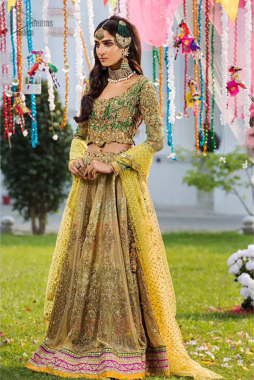 A perfectly pretty combination for a mehndi function. Gussy up the glamour with this intricate embroidered blouse accentuated with golden kora, dabka and tilla work and scalp finishing. The lehenga is emphasized with traditional style done with zardozi work in the shade of golden. Furthermore it is adorned with multiple color applique bottom which complete the look. It is coordinated with yellow dupatta sprinkled with sequins on the ground and scallop border. 