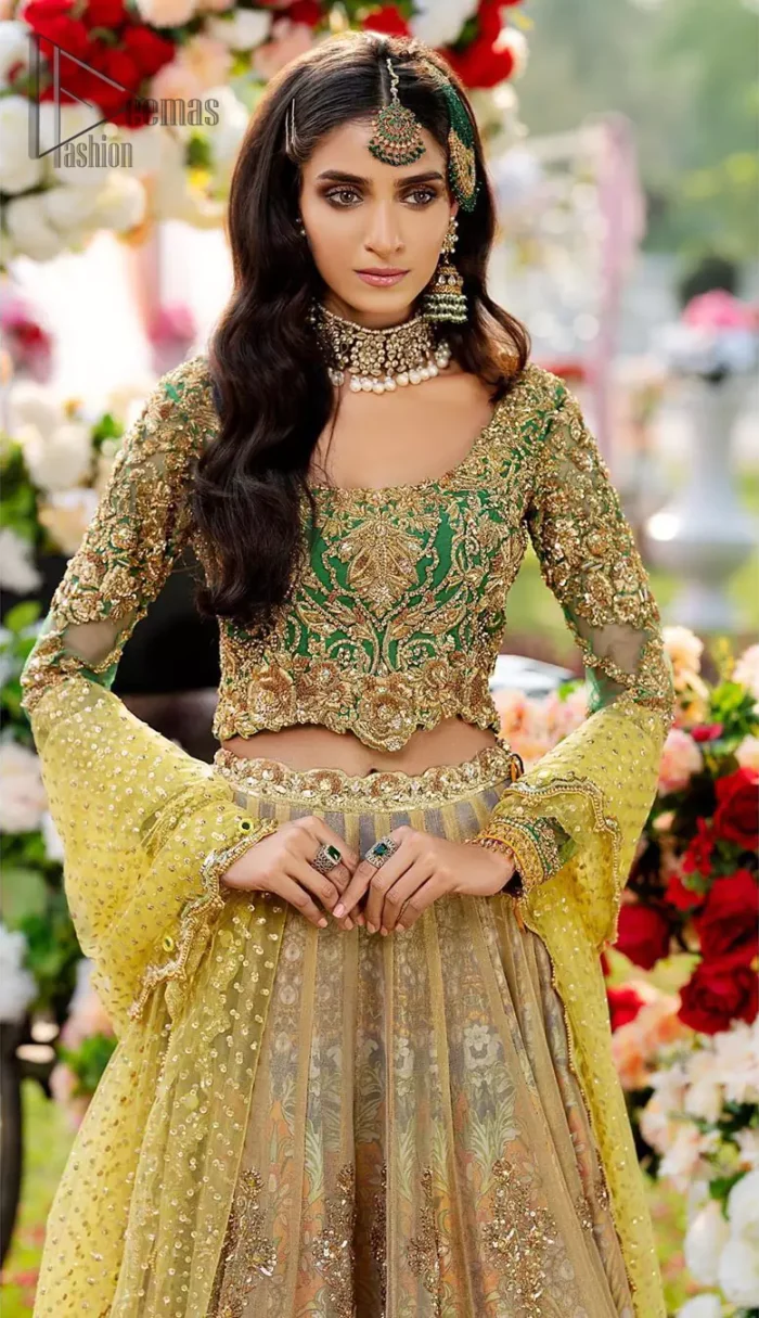 A perfectly pretty combination for a mehndi function. Gussy up the glamour with this intricate embroidered blouse accentuated with golden kora, dabka and tilla work and scalp finishing. The lehenga is emphasized with traditional style done with zardozi work in the shade of golden. Furthermore it is adorned with multiple color applique bottom which complete the look. It is coordinated with yellow dupatta sprinkled with sequins on the ground and scallop border. 