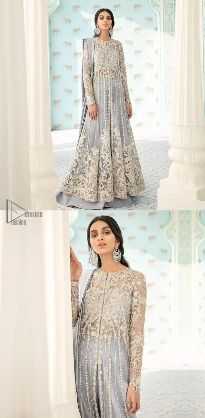 You are all set to make a lasting impact with the divine royalty of this dress. This artisan piece includes intricate hand-embellishment. This technique gives this garments a unique look, and helps to sustain a traditional craft carried out by skilled artisans. This multiple panels front open maxi is ornamented by light gold zardozi work with beautiful embellished motifs around the hem and vertically worked gold lines. It comprises with raw silk sharara adorned with tiny floral motifs and dupatta is decorated with sequins spray all over.