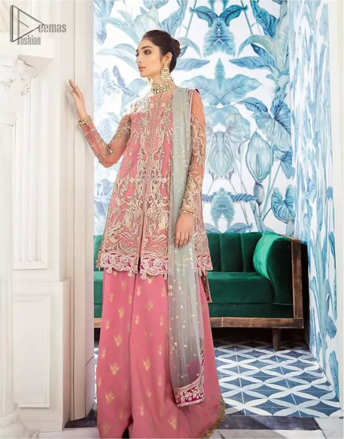 Let the crowd stare and make it worth their while when you walk wearing this outfit. A perfect ensemble for this festive season with divine detailing of thread embroidery, color balance and well-crafted applique hemline. The front open frock is fully embellished with floral embroidery done with light golden zardozi work and thread embroidery. It comprises with pink self fabric sharara and mint green dupatta, adorned with sequins spray on the ground and embellished pink applique pallu. You would definitely want to wear this for your next occasion.