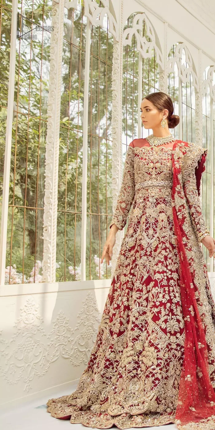 This bridal dress is perfect for your big day. Our bride makes a statement in this stunningly floraison, perfect blend of glamour and tradition with outstanding craftsmanship and gorgeous detailing. This floor length maxi is beautifully sculptured floral jhaal, floral bunches and thick scalloped hemline done with light golden kora, dabka, tilla and sequins embroidery. Exude elegance with red lehenga finessed with beautiful embellished scalloped bottom with zardosi work. The red net dupatta with chann and finishing all around the edges makes the look complete.
