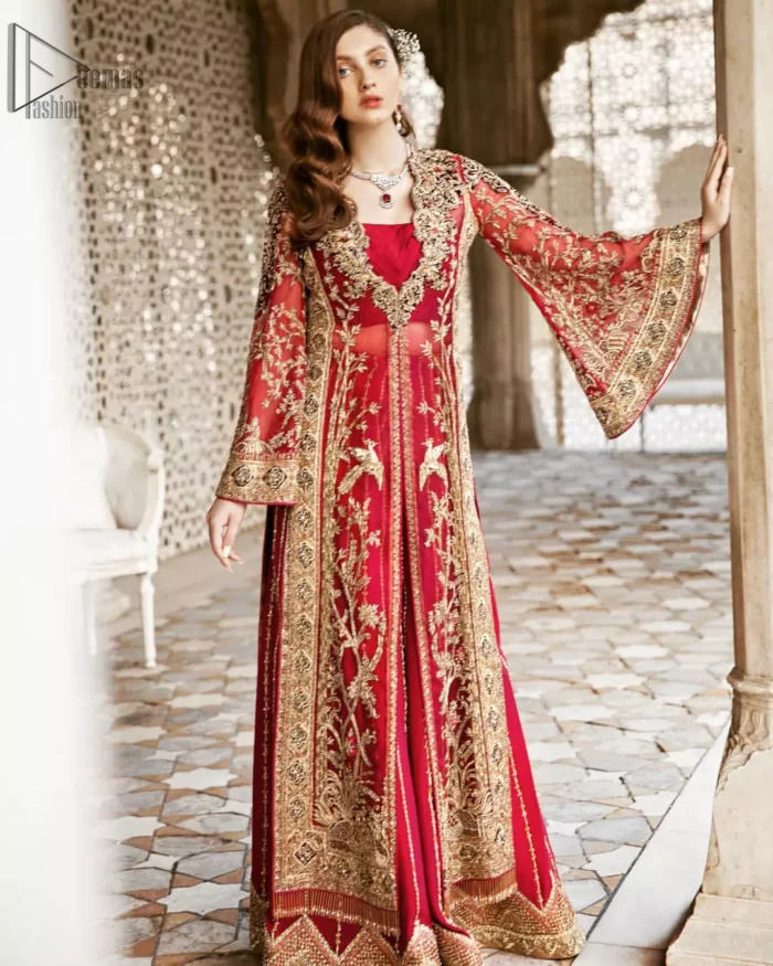 Beautifully elegant with a modern twist. This dress is crafted from delicate floral lace and features a scalloped plunge neckline. The front of the gown is adorned with floral embroidery, bunches and thick embellished side slits done with golden and antique zardozi work. Back of the gown is emphasized with black applique detailing and geometric patterns. The gown is finishing with tassels on the hemline on both sides frond and back. The palazzo pants is adorned with thick embellished applique bottom with golden kora, dabka, tilla and sequins embroidery. It comprises with red chiffon dupatta with sequins spray all over.