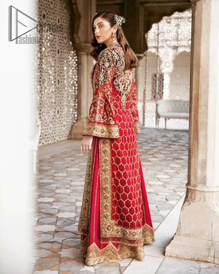 Beautifully elegant with a modern twist. This dress is crafted from delicate floral lace and features a scalloped plunge neckline. The front of the gown is adorned with floral embroidery, bunches and thick embellished side slits done with golden and antique zardozi work. Back of the gown is emphasized with black applique detailing and geometric patterns. The gown is finishing with tassels on the hemline on both sides frond and back. The palazzo pants is adorned with thick embellished applique bottom with golden kora, dabka, tilla and sequins embroidery. It comprises with red chiffon dupatta with sequins spray all over.