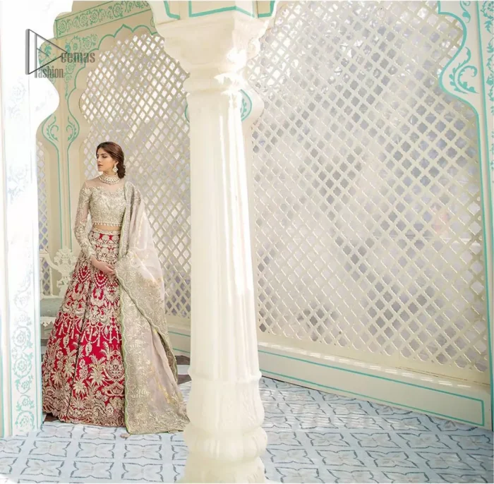 This elegant ensemble turns timeless piece into a chic fantasy. Best choice for your wedding day. This outfit is enhanced with hand embellishments on bodice and sleeves finishing with dangling tassels on the blouse. The lehenga is an amalgamation of a variety of our signature motifs, fine materials, and traditional yet contemporary silhouettes. Crafted from the prettiest zardozi work. Paired it up with off white self fabric dupatta having four sided embroidered border. 