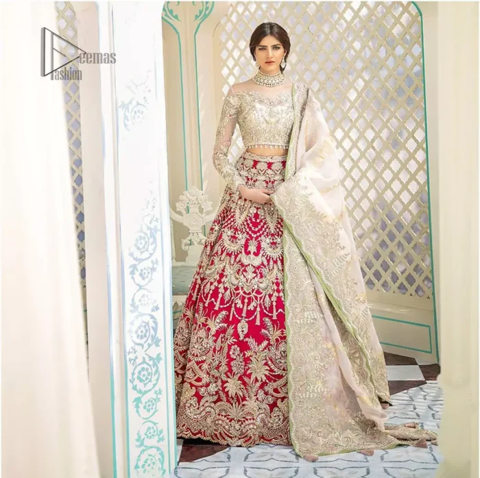This elegant ensemble turns timeless piece into a chic fantasy. Best choice for your wedding day. This outfit is enhanced with hand embellishments on bodice and sleeves finishing with dangling tassels on the blouse. The lehenga is an amalgamation of a variety of our signature motifs, fine materials, and traditional yet contemporary silhouettes. Crafted from the prettiest zardozi work. Paired it up with off white self fabric dupatta having four sided embroidered border. 
