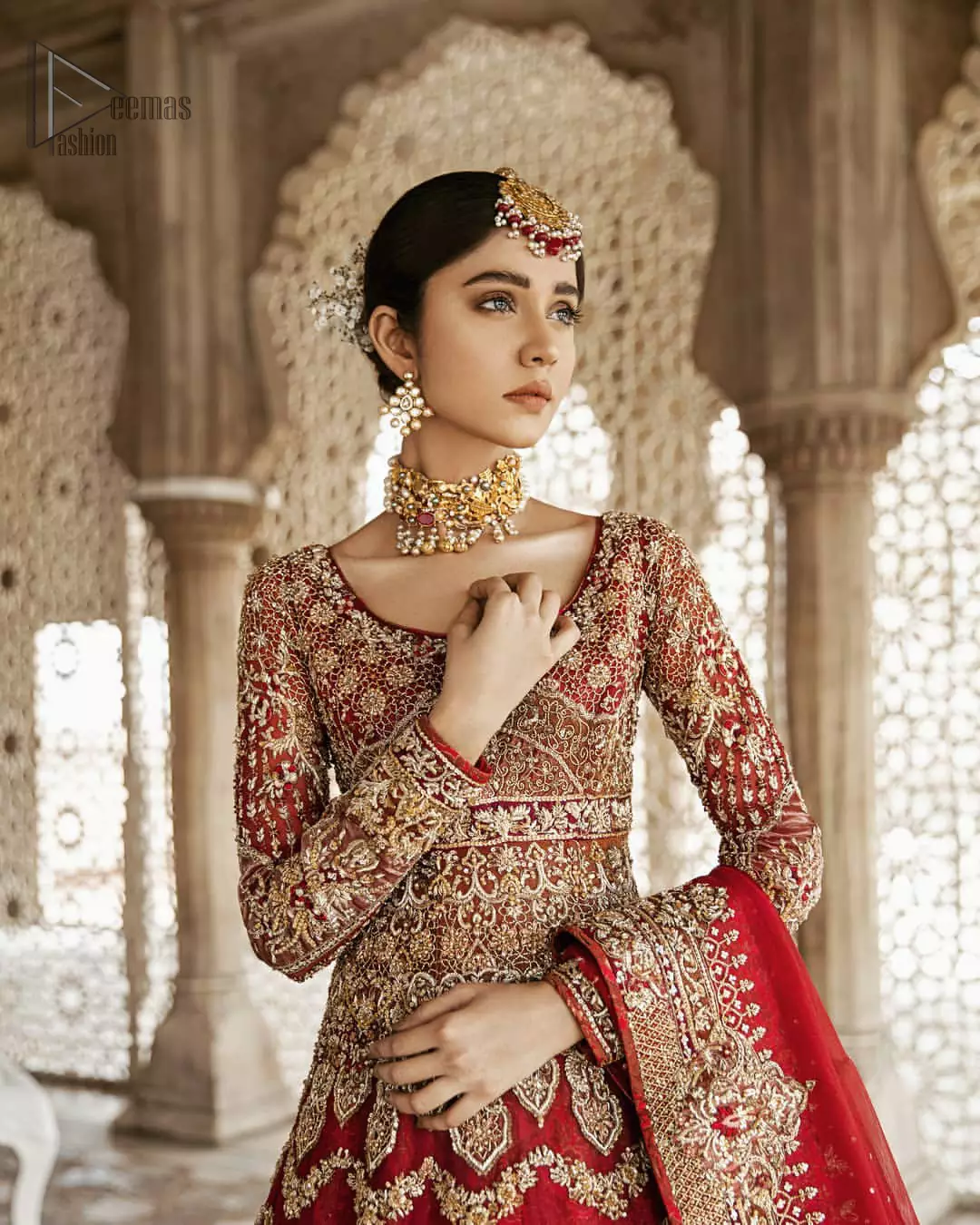 Captured in traditional silhouette, This traditional red pishwas is aesthetically designed with motifs,geometric and floral patterns, embellished with kora, dabka, tilla and sequins work. It comes with full embellished lehenga which is gorgeously handcrafted with golden and antique shaded zardozi work. The piece comes with a handcrafted belt. It is coordinated with net dupatta which is sprinkled with sequins all over it. It is further furnished with four sided border and floral bunches.