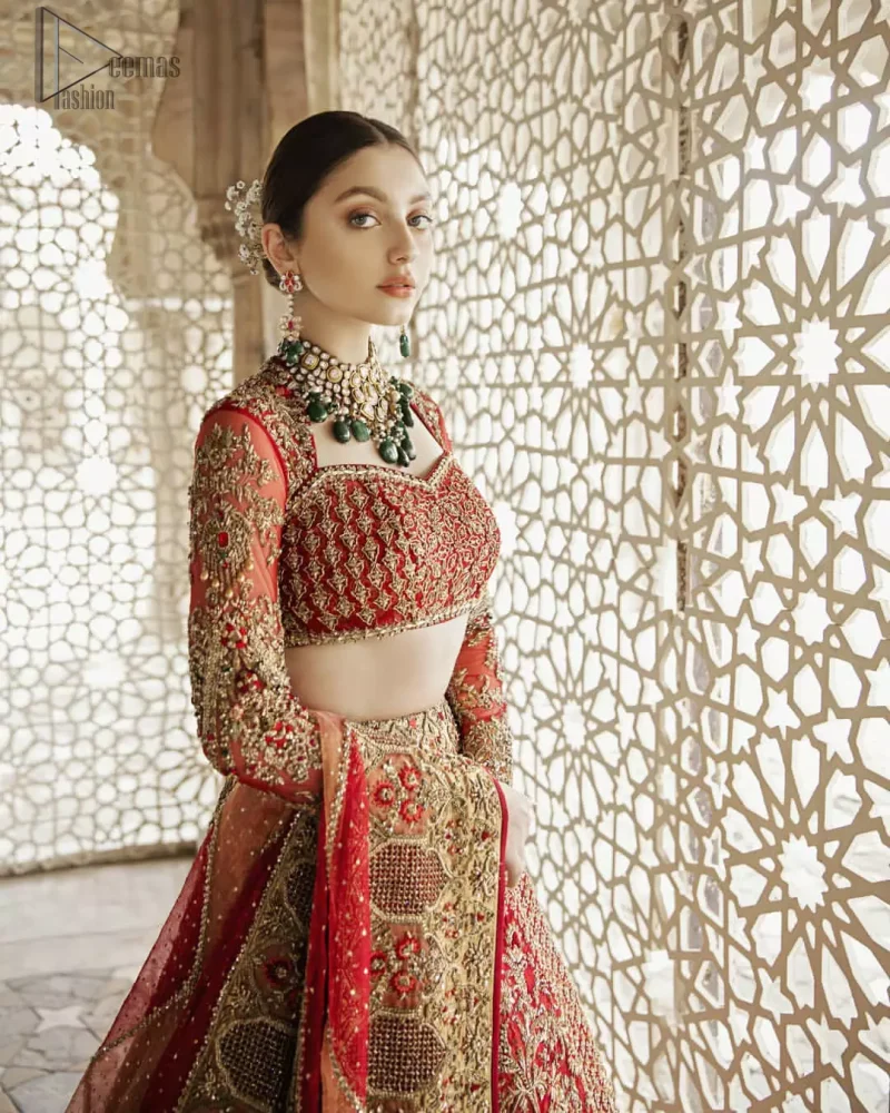 Classic, timeless and truly beautiful, our bridal dress is perfect for your unforgettable day. This exceptionally detailed dress is cut in a seductive fit and flare silhouette that’s sure to turn heads. The blouse is adorned with antique shaded kora, dabka, tilla, kundan, sequins and pearls. Coordinated with traditional red lehenga having geometric patterns and floral embroidery ornamented with antique shaded zardozi work. The hemline is also adorned with vibrant floral motifs. Elegance is personified when it gets paired up with red organza dupatta having four sided thick embellished border.
