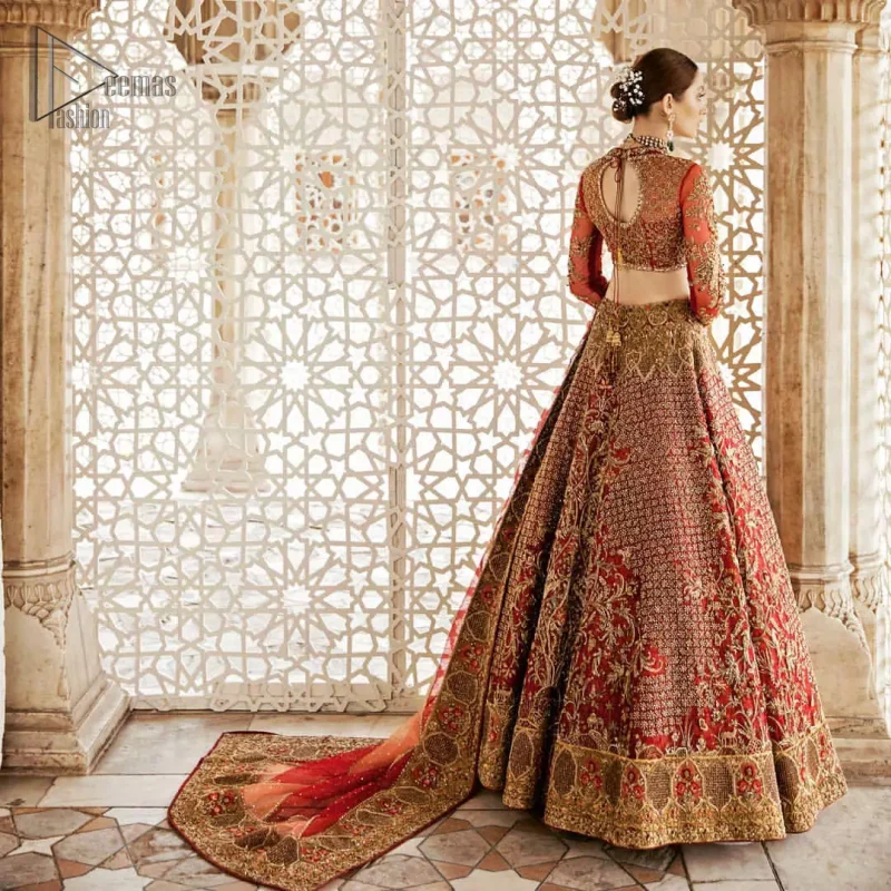 Classic, timeless and truly beautiful, our bridal dress is perfect for your unforgettable day. This exceptionally detailed dress is cut in a seductive fit and flare silhouette that’s sure to turn heads. The blouse is adorned with antique shaded kora, dabka, tilla, kundan, sequins and pearls. Coordinated with traditional red lehenga having geometric patterns and floral embroidery ornamented with antique shaded zardozi work. The hemline is also adorned with vibrant floral motifs. Elegance is personified when it gets paired up with red organza dupatta having four sided thick embellished border.