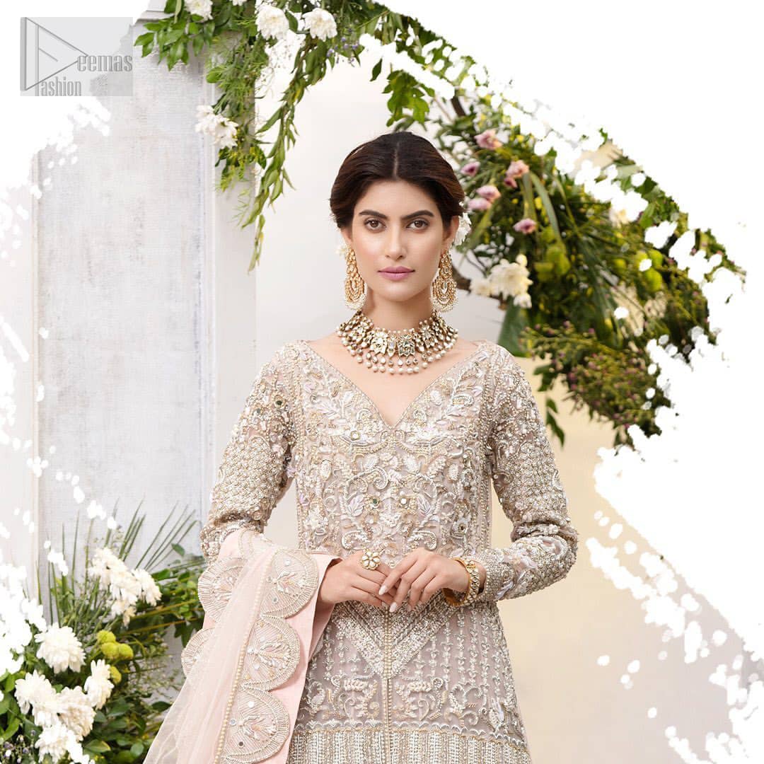 Make a special day even more magic with our exquisite flora bridal maxi dress. Discover classic look in this outfit for a traditional style, with delicate detailing and intricate accents for a subtle yet sophisticated look, having full sleeves with zardozi details. Furthermore the hemline is emphasized with a large central motif and small motifs around it that gives perfect ending to the outfit. It comes with tea pink lehenga with zardozi details on the bottom. Paired with light purple net dupatta sprinkled with sequins and four sided embellished border that gives the right amount of glamour to the outfit.