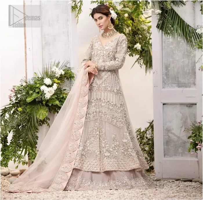 Make a special day even more magic with our exquisite flora bridal maxi dress. Discover classic look in this outfit for a traditional style, with delicate detailing and intricate accents for a subtle yet sophisticated look, having full sleeves with zardozi details. Furthermore the hemline is emphasized with a large central motif and small motifs around it that gives perfect ending to the outfit. It comes with tea pink lehenga with zardozi details on the bottom. Paired with light purple net dupatta sprinkled with sequins and four sided embellished border that gives the right amount of glamour to the outfit.