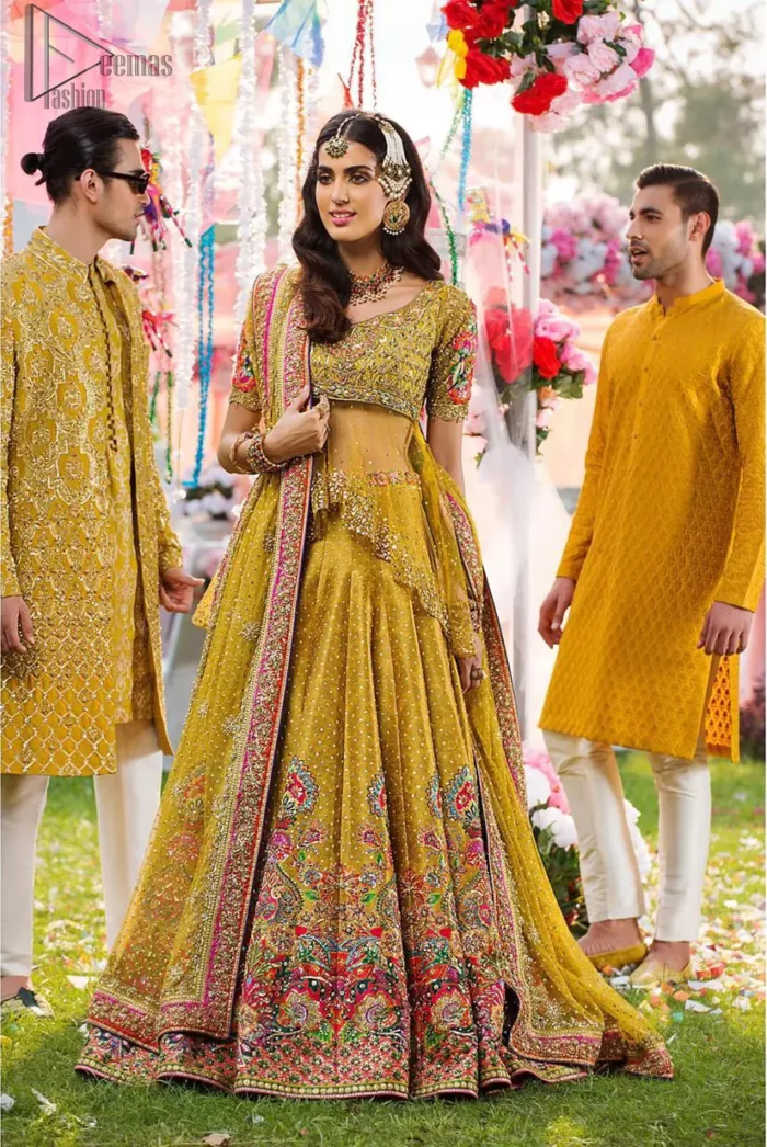 The perfect choice for Mahendi. Delicately crafted and personifying chic elegance with an element of grandiose. The shirt is emphasized with traditional neckline and a small back train. And the lehenga is decorated with intricate floral daaman enhanced with multiple color thread embroidery and rich zardozi work. Paired it up with yellow net dupatta sprinkled with sequins on the ground and four sided applique border.