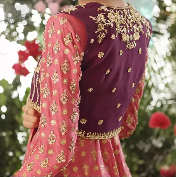 This exceptionally detailed dress is cut in a seductive fit and flare silhouette that’s sure to turn heads. Discover classic look with coral pishwas adorned with delicate detailing and intricate accents for a subtle yet sophisticated look, including long sleeve with tiny floral booties details. The neckline is doecorated with dull golden zardozi work and scattered tiny floral booties all over the pishwas. This outfit is coordinated with dark magenta bolero jacket which is beautifully ornamented with dull golden kora, dabka detailing. Paired it up with coral churidar pajama and dark magenta self printed dupatta.