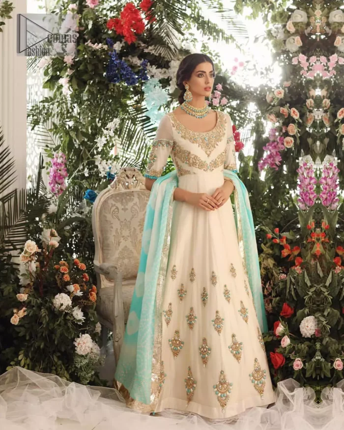 This outfit should be the next addition to your wardrobe. An example of beauty and elegance. Look breathtakingly stylish in this embroidered regalia furnished with intricate embroidered neckline which is embellished with antique shaded zardozi work and ferozi stones. Furthermore, this multiple panel frock is adorned with different sized motifs scattered all over the frock. It is coordinated with ivory churidar pajama. Finished the look with self printed chiffon dupatta having four sided applique on it.