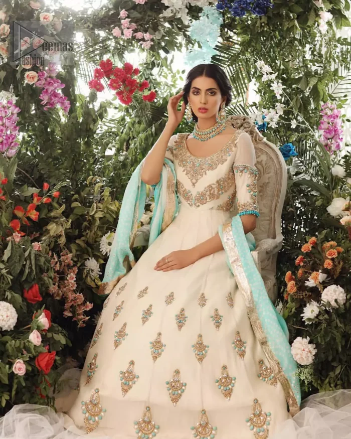 This outfit should be the next addition to your wardrobe. An example of beauty and elegance. Look breathtakingly stylish in this embroidered regalia furnished with intricate embroidered neckline which is embellished with antique shaded zardozi work and ferozi stones. Furthermore, this multiple panel frock is adorned with different sized motifs scattered all over the frock. It is coordinated with ivory churidar pajama. Finished the look with self printed chiffon dupatta having four sided applique on it.