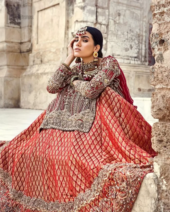 You are all set to make a lasting impact with the divine royalty of this dress. This beautiful dress comes with a maroon back train lehenga with beautiful embellishment around the hem. The shirt is adoned with golden zardozi work around the neckline and vertically worked gold lines and it finished with a thick embellished border. The sleeves are embellished with motifs all over along with a thick embroidered border. The dupatta incorporates beautifully designed borders on all four sides, focusing on the heavily embellished pallu borders to give it a perfect maharani look.