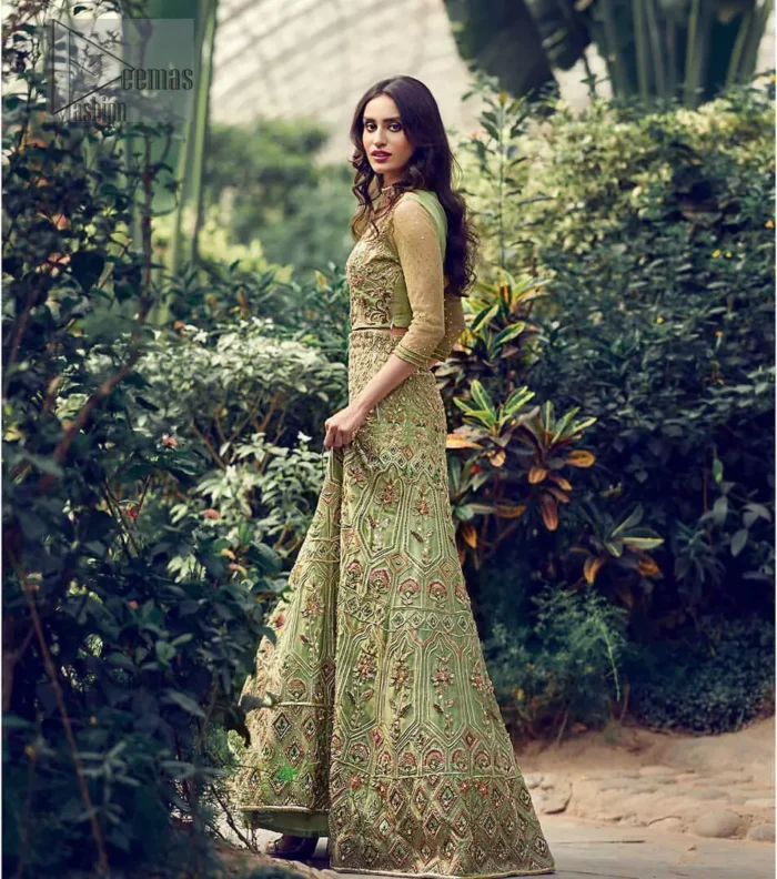 Nothing speaks of femininity and class louder than this mehndi outfits for bridesmaids. Steal the moment with this outfit with this shabby chic statement intensified with rich thread embroidery all over the front and bold patterns at daaman od the lehenga. Furthermore, it is enhanced with floral motifs all over decorated with multiple color thread embroidery. It is coordinated with parrot green blouse done with golden zardozi work and three quarter sleeves. Style it up with chiffon dupatta scattered with sequins all over.