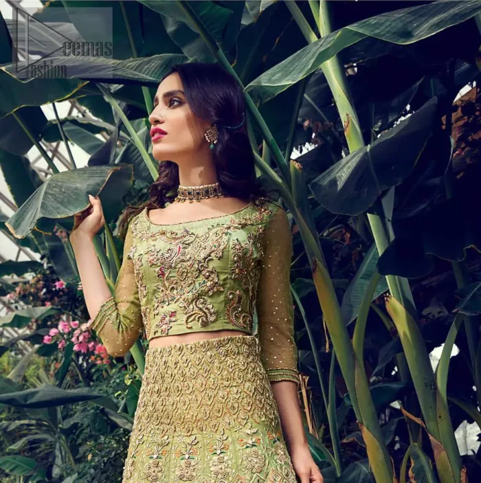 Nothing speaks of femininity and class louder than this mehndi outfits for bridesmaids. Steal the moment with this outfit with this shabby chic statement intensified with rich thread embroidery all over the front and bold patterns at daaman od the lehenga. Furthermore, it is enhanced with floral motifs all over decorated with multiple color thread embroidery. It is coordinated with parrot green blouse done with golden zardozi work and three quarter sleeves. Style it up with chiffon dupatta scattered with sequins all over.