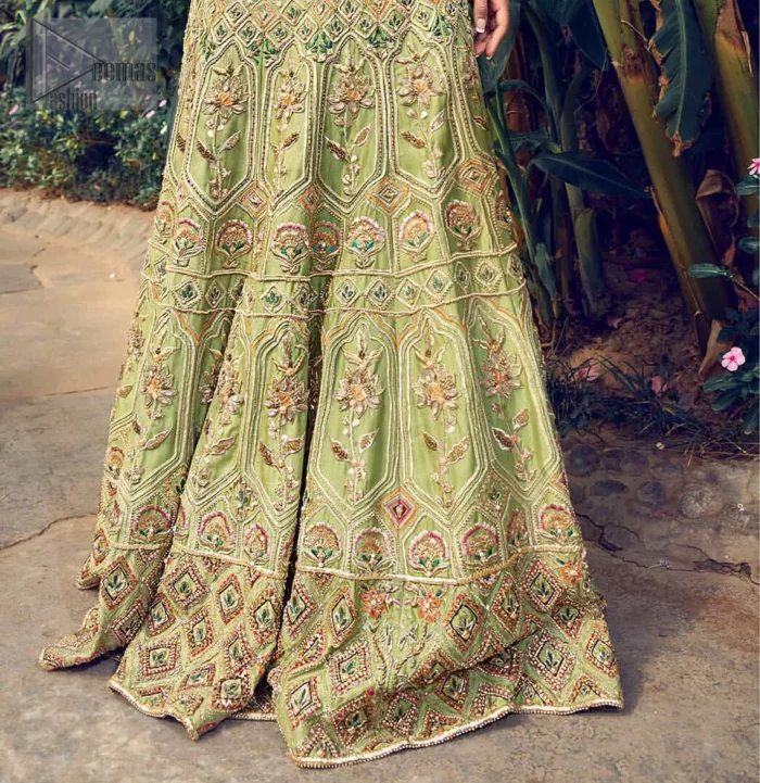 Nothing speaks of femininity and class louder than this mehndi outfits for bridesmaids. Steal the moment with this outfit with this shabby chic statement intensified with rich thread embroidery all over the front and bold patterns at daaman od the lehenga. Furthermore, it is enhanced with floral motifs all over decorated with multiple color thread embroidery. It is coordinated with parrot green blouse done with golden zardozi work and three quarter sleeves. Style it up with chiffon dupatta scattered with sequins all over.