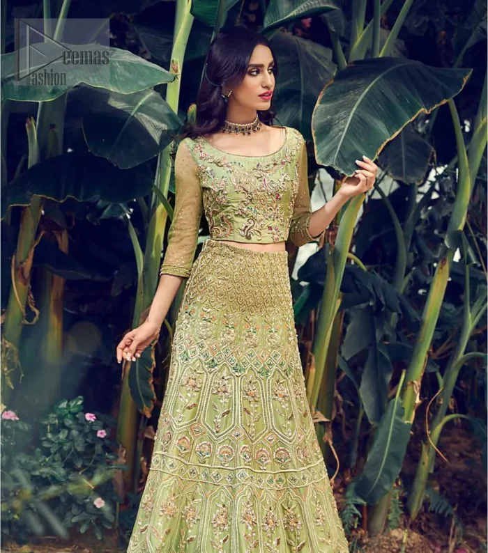 Nothing speaks of femininity and class louder than this mehndi outfits for bridesmaids. Steal the moment with this outfit with this shabby chic statement intensified with rich thread embroidery all over the front and bold patterns at daaman od the lehenga. Furthermore, it is enhanced with floral motifs all over decorated with multiple color thread embroidery. It is coordinated with parrot green blouse done with golden zardozi work and three quarter sleeves. Style it up with chiffon dupatta scattered with sequins all over.