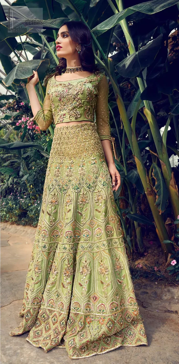Nothing speaks of femininity and class louder than this mehndi outfits for bridesmaids. Steal the moment with this outfit with this shabby chic statement intensified with rich thread embroidery all over the front and bold patterns at daaman od the lehenga. Furthermore, it is enhanced with floral motifs all over decorated with multiple color thread embroidery. It is coordinated with parrot green blouse done with golden zardozi work and three quarter sleeves. Style it up with chiffon dupatta scattered with sequins all over.